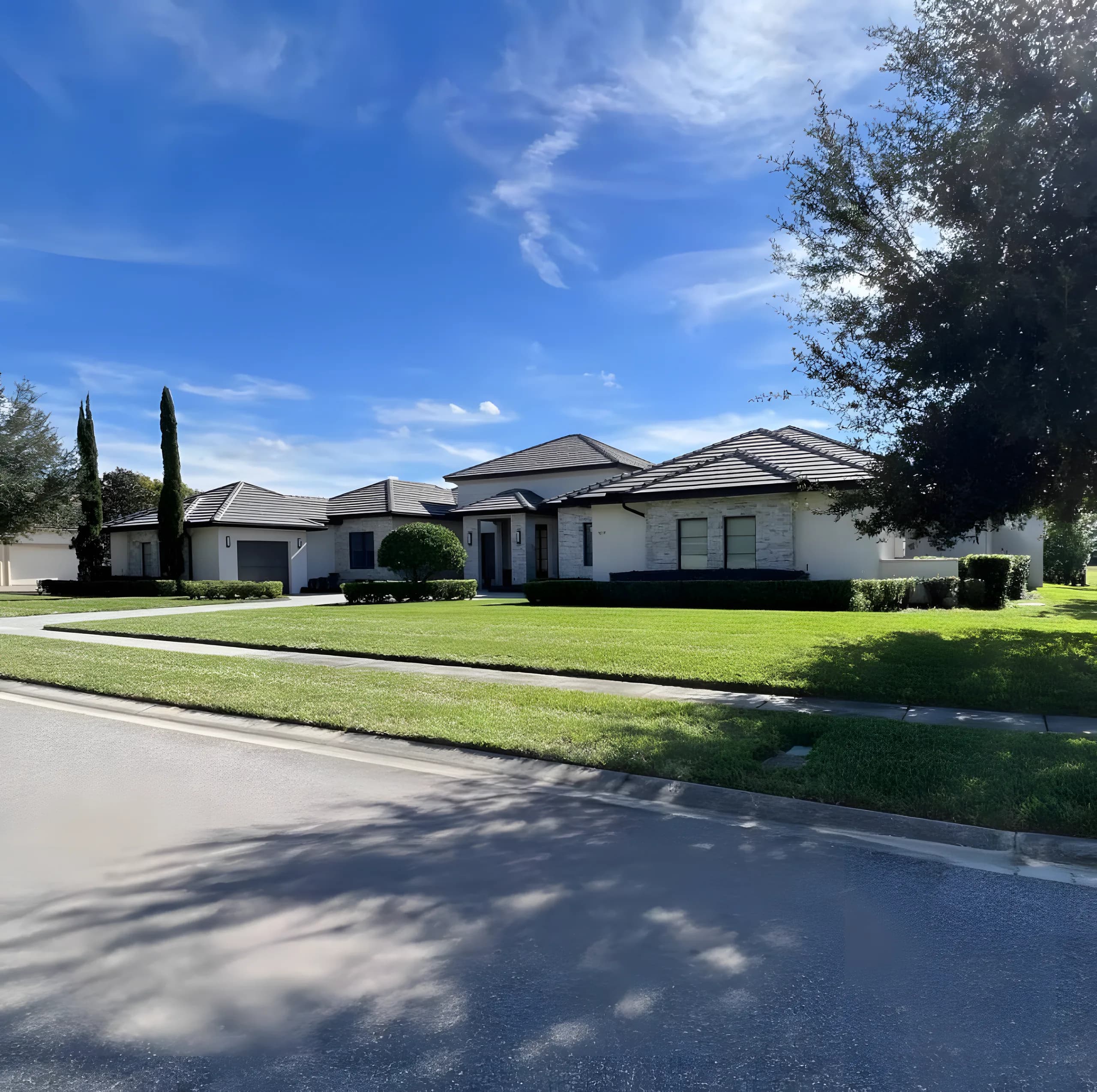 Mowed front lawns along a sunny residential street