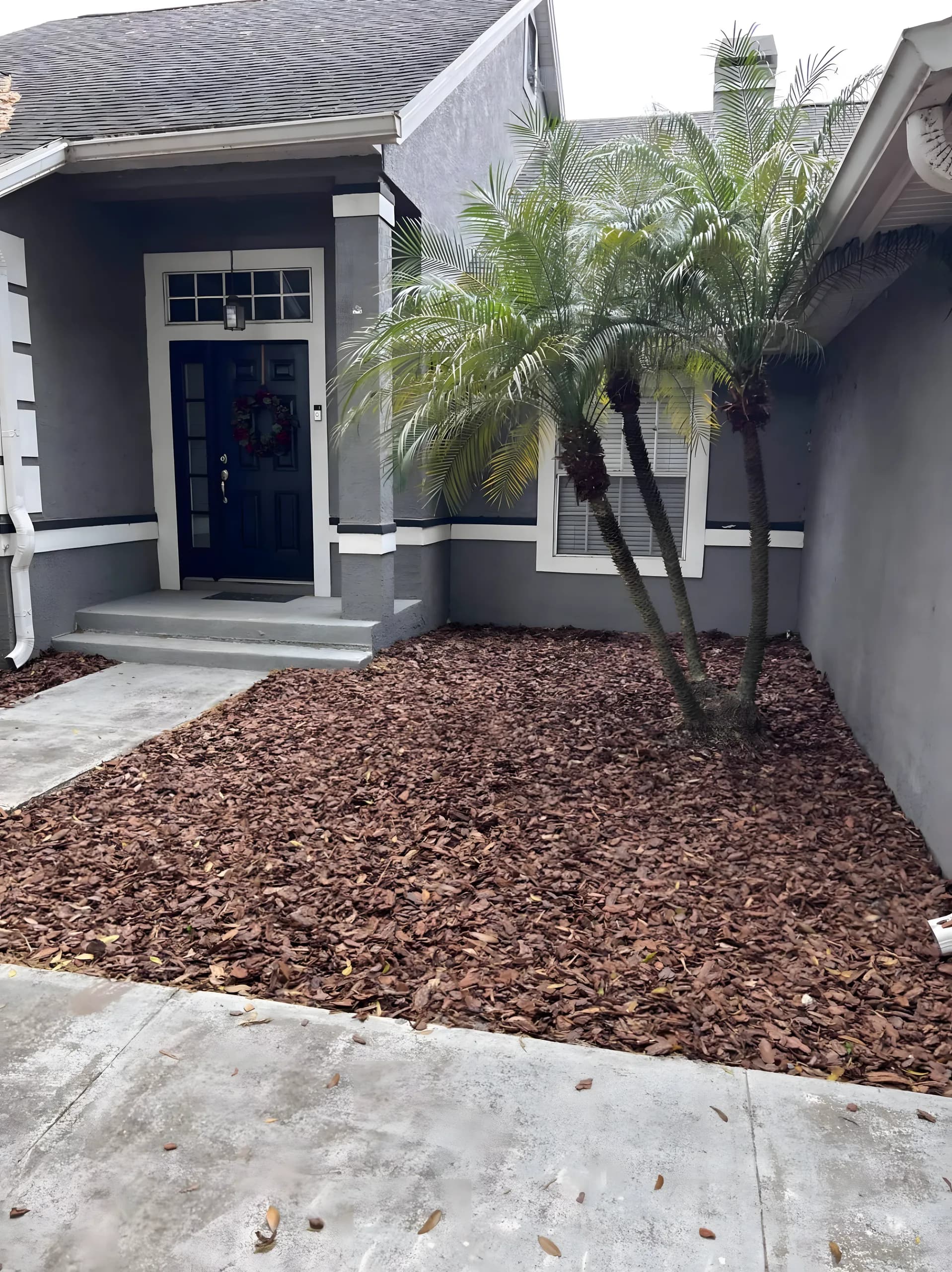 Red mulch beds at a home's front entry